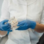 Dentist Holding Dental Model In Hand Teeth Grinding - Trade Winds Dental